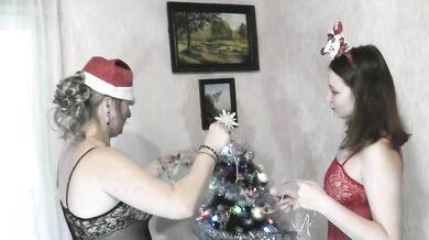 Mature lesbian MILF and bisexual teen in erotic lingerie without panties decorate Christmas tree for New Year 2026 Hairy pussy Shaved Ass Natural tits
