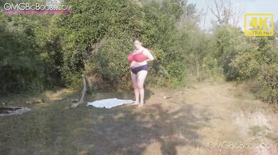 Showing massive tits outside