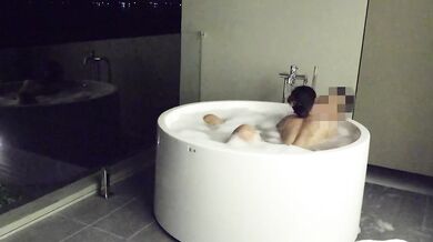 Asian couple having sex in an outdoor jacuzzi, someone is peeking.