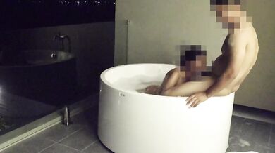 Asian couple having sex in an outdoor jacuzzi, someone is peeking.