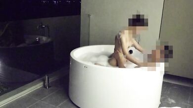 Asian couple having sex in an outdoor jacuzzi, someone is peeking.