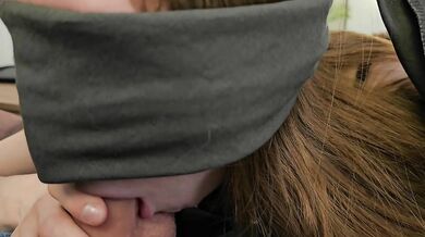 A red-haired girl with a deep throat and blindfolded sucks a dick while drooling