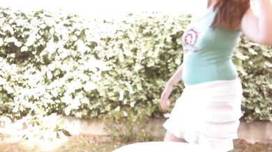Dirty piss-filled diaper shown in a public garden under a white skirt