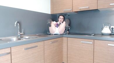 Schoolgirl plays in the kitchen