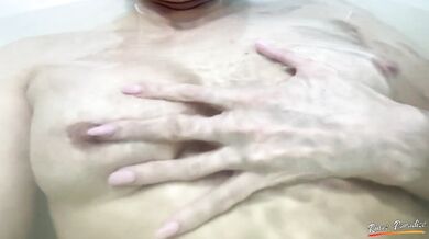 Boobs massage. A schoolgirl is playing with her boobs in the bathroom under the water