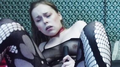 A GIRL IN A BLACK BODYSUIT PLAYS WITH HERSELF