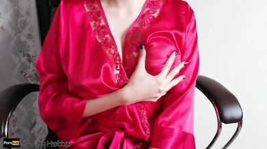 Girl in a sexy robe shows boobs in oil