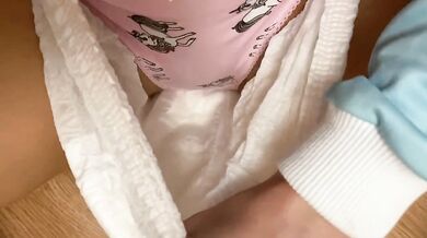 By the Christmas tree pissing in cute panties under a diaper