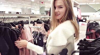 A cute girl sucks a dick and takes cum in her mouth, in a fitting room, in a shopping center