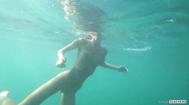 Nude model swims on a public beach in Russia