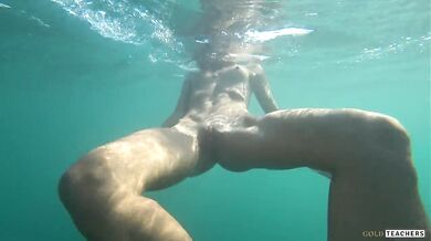 Nude model swims on a public beach in Russia
