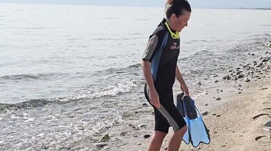 Hot Diver Flashing on Public Beach
