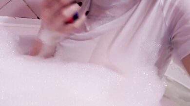 having fun in the bathtub with foam in a wet white top. I smoke and listen to 2rbina2rists