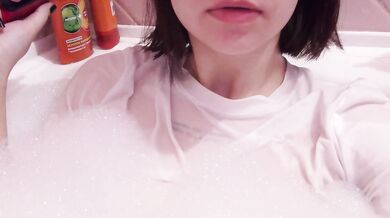 having fun in the bathtub with foam in a wet white top. I smoke and listen to 2rbina2rists