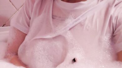 having fun in the bathtub with foam in a wet white top. I smoke and listen to 2rbina2rists