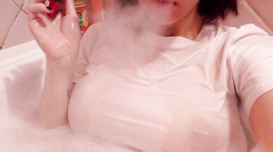 having fun in the bathtub with foam in a wet white top. I smoke and listen to 2rbina2rists