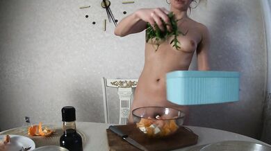 Naked Girl cooks salad