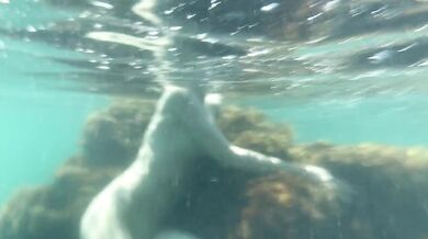 Naked girl swims in the sea and masturbate underwater