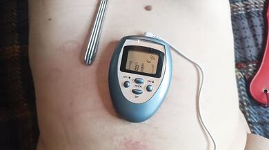 BDSM electro stimulation of dick in chastity belt, play with nipples.