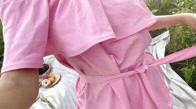 Young slut in pink dress masturbates outdoors