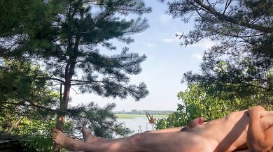 A warm breeze gently blows over him, and he smoothly moves the skin on his cock...