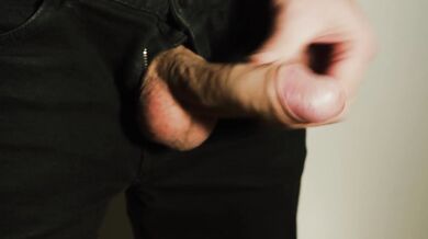 Thick uncut dick growing in black jeans. Natural foreskin. Cum on black plate.