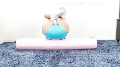 Rhythmic gymnastics stretching of a small woman in GKElite leotard excited by sexy yoga spandex,