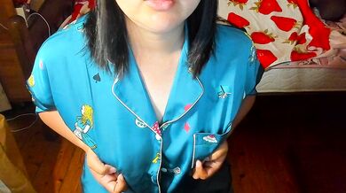 A busty Japanese woman in pajamas masturbates with her nipples before going to bed.