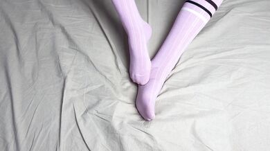 Pink socks in hands of mistress with blue nails in solo video