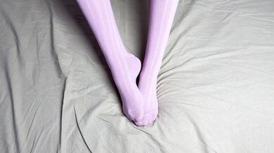 Pink socks in hands of mistress with blue nails in solo video