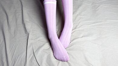 Pink socks in hands of mistress with blue nails in solo video
