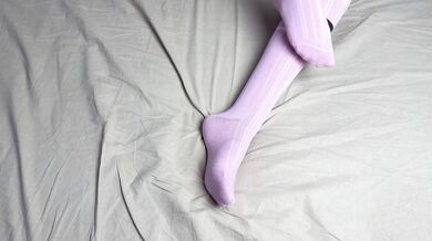 Pink socks in hands of mistress with blue nails in solo video