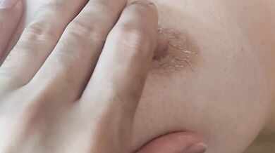 A hard, excited female nipple gets an orgasm from touching