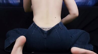 ASIAN GIRL IN BLUE JEANS RUBS PEETS ON PILLOW