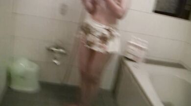 A mature woman naughty MILF blows in the shower room after swimming in the sea.