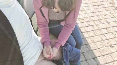 stepdaughter blows stepfather on a bench in a public park
