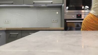 Long hair long legs hot blonde college girl on high heels and a miniskirt which does not cover her ass in the kitchen