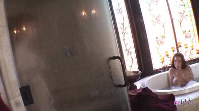 Instead of showering, two busty babes pleased each other with a dildo in the bathtub