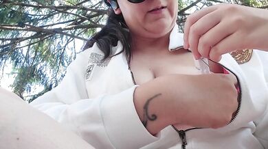 Smoking in a public garden tits outside and feet in flip flops