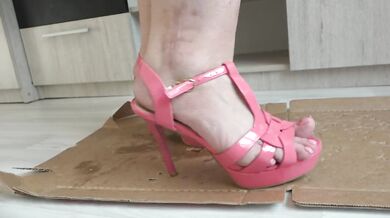 Big legs in open shoes crush and trample the box with high heels to cod.
