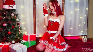 Christmas elf girl sweetly playing with her ass