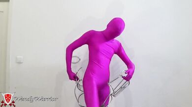 My Iron Maiden Corset is locked over a pink zentai