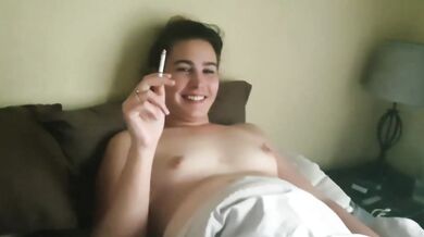 chubby girl smoking a cigarette in bed