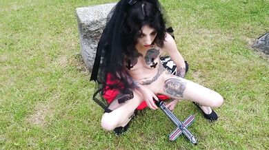 Blasphemic satanic whore fucking her pussy and ass in an old cemetary