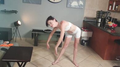 Flexible petite girl pissing through white pants into her mouth