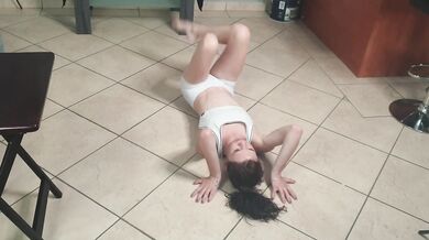 Flexible petite girl pissing through white pants into her mouth