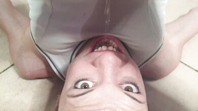Flexible petite girl pissing through white pants into her mouth