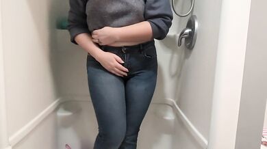 Naughty girl desperately pisses jeans in shower