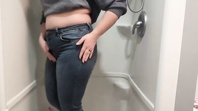 Naughty girl desperately pisses jeans in shower