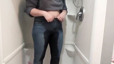 Naughty girl desperately pisses jeans in shower